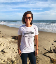 Load image into Gallery viewer, Not Captivated By Captivity White Unisex Tee